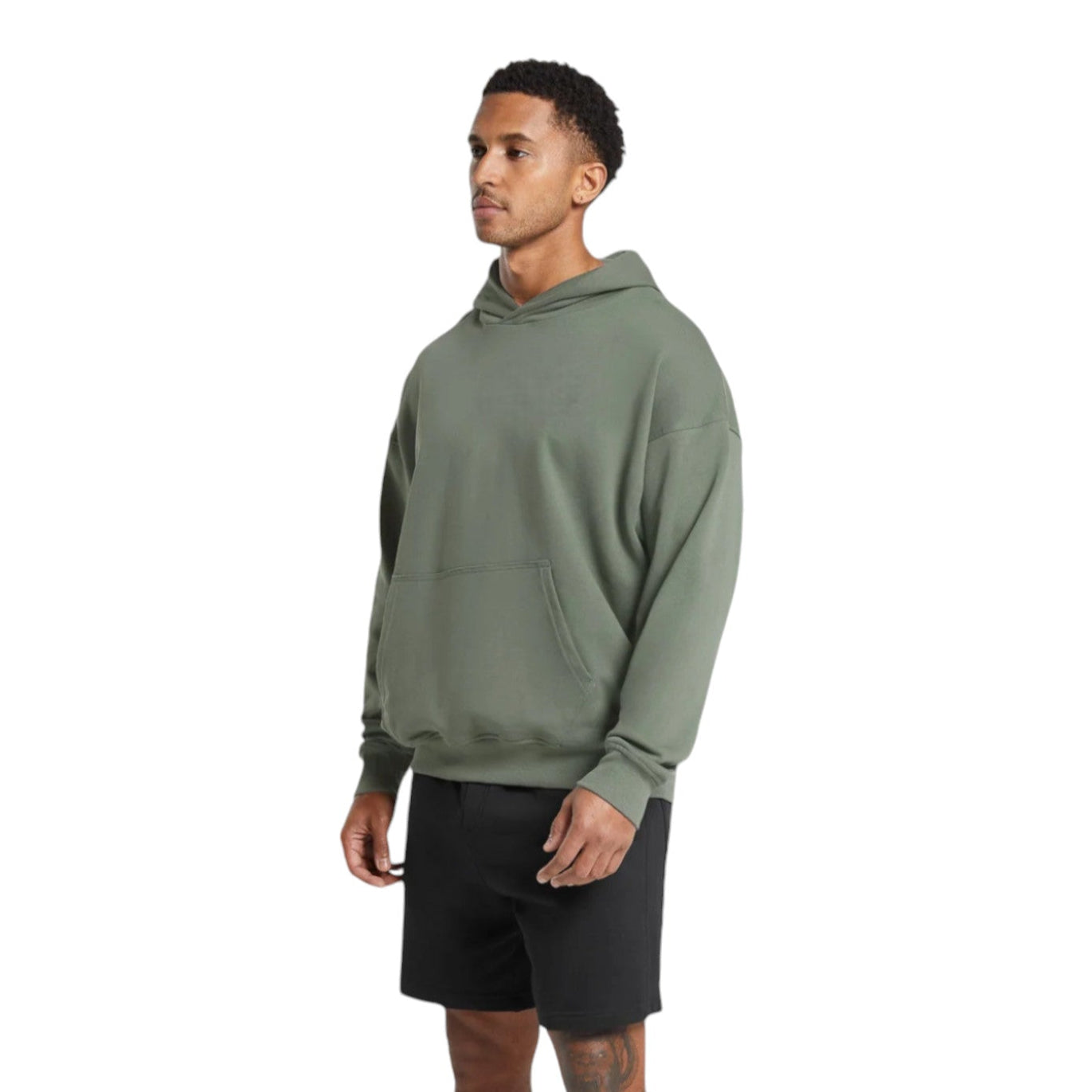 Man wearing a green hoodie and black shorts on a white background