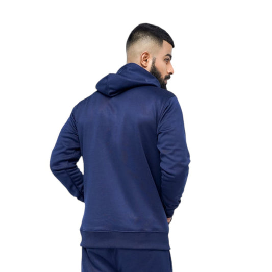 Man wearing a blue tracksuit on a white background