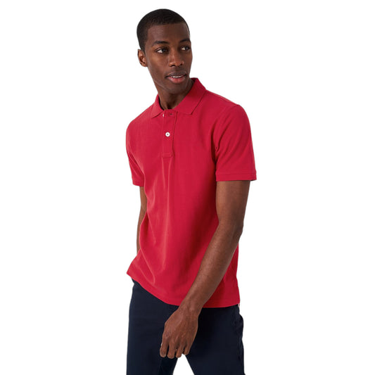 A man wearing a classic red short-sleeved polo shirt with a collar and a two-button placket.