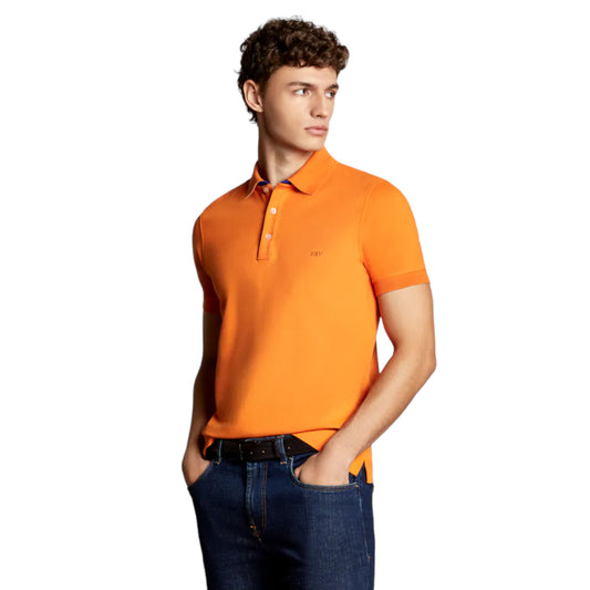 A man wearing an orange plain pique polo shirt with a classic collar and a three-button placket.