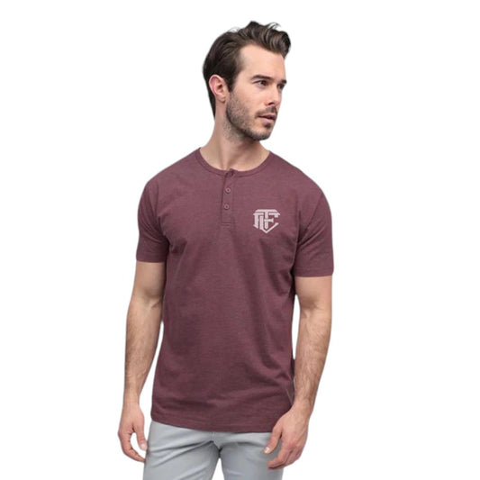A man wearing a maroon henley shirt with a logo on the chest.