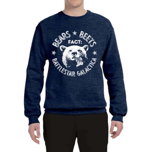 A person wearing a navy blue sweatshirt with a graphic inspired by the TV shows Bears Beets Battlestar Galactical.