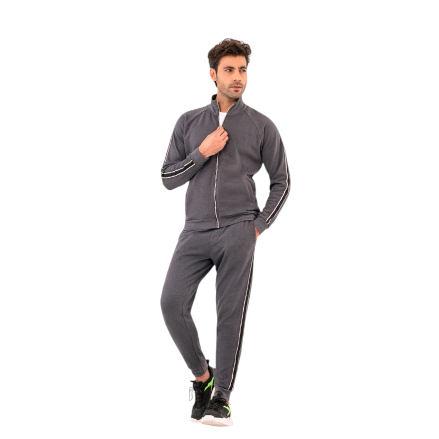 A man wearing a modern grey tracksuit with a zipper jacket and striped joggers. The tracksuit is designed with contrasting stripes for a contemporary look.