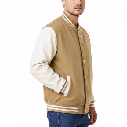 Man wearing a beige varsity jacket with white sleeves and collar on a white background