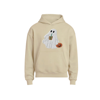 Beige hoodie with a ghost design holding a coffee cup and pumpkin on a white background