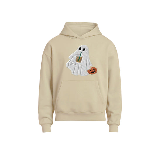 Beige hoodie with a ghost design holding a coffee cup and pumpkin on a white background
