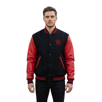 Man wearing a black and red varsity jacket on a white background