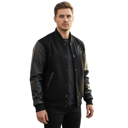 Man wearing a black varsity jacket with leather sleeves on a white background