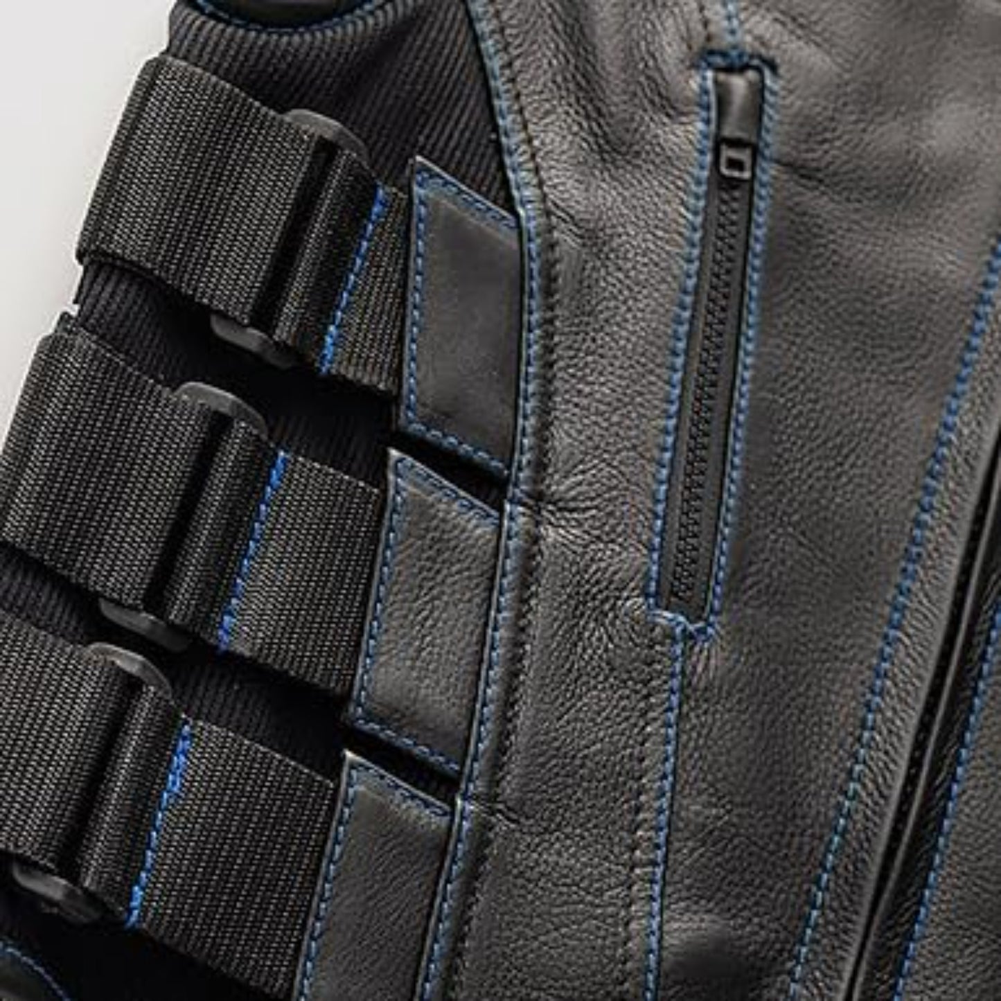 Close-up of a gray tactical vest with black straps and blue stitching on a white background