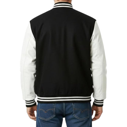 Black and white varsity jacket with blue jeans on a white background