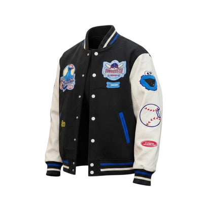 Black and white varsity jacket with colorful patches on a white background