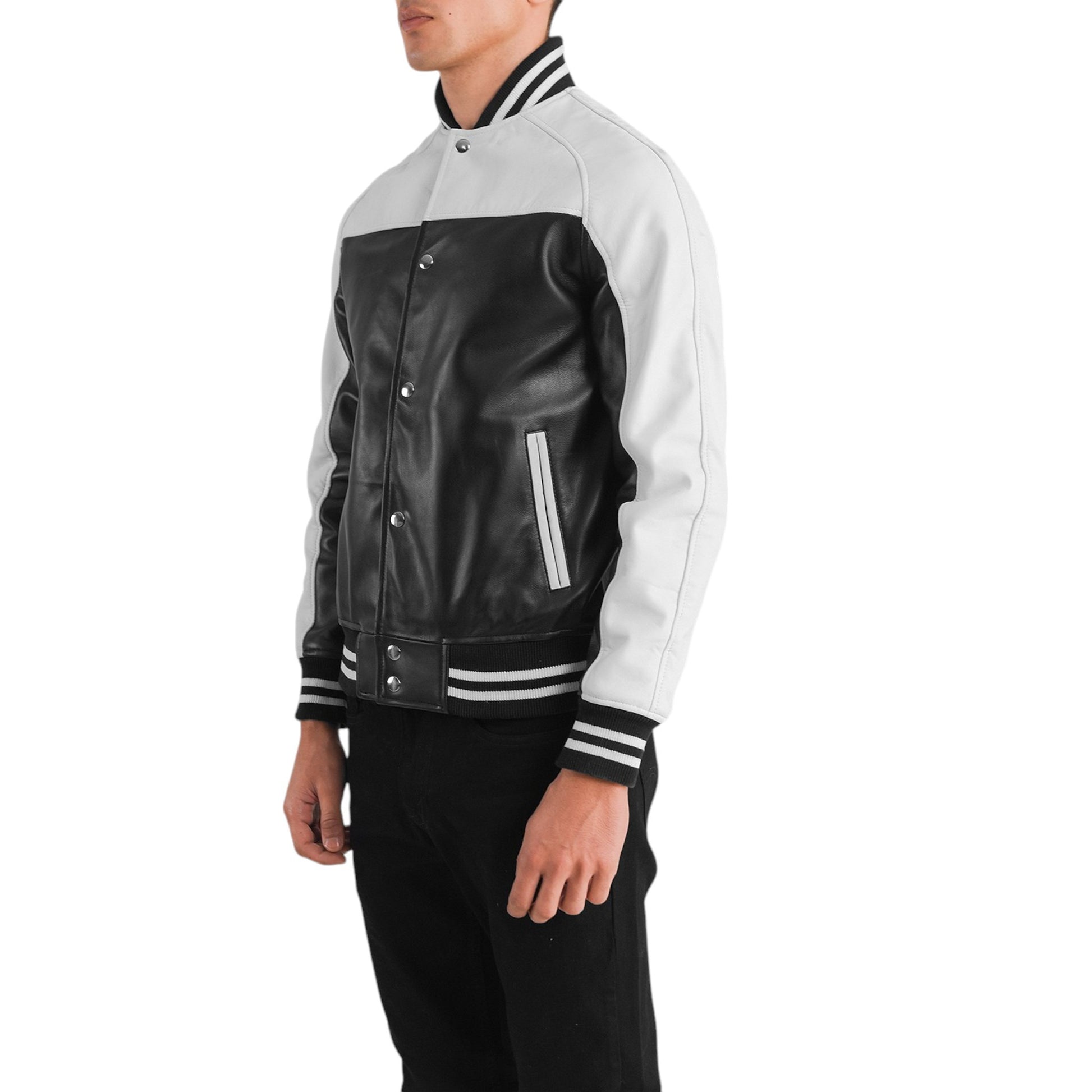 Person wearing a black and white varsity jacket on a white background