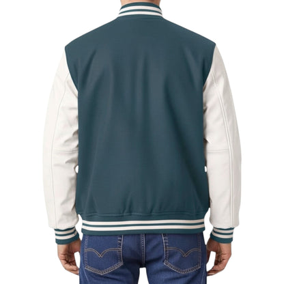 Back view of a person wearing a blue and white varsity jacket with denim pants on a white background