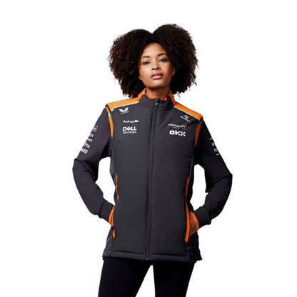 Person wearing a black and orange jacket with branding on a white background