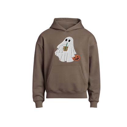 Brown hoodie with a ghost design holding a drink and a pumpkin on a white background