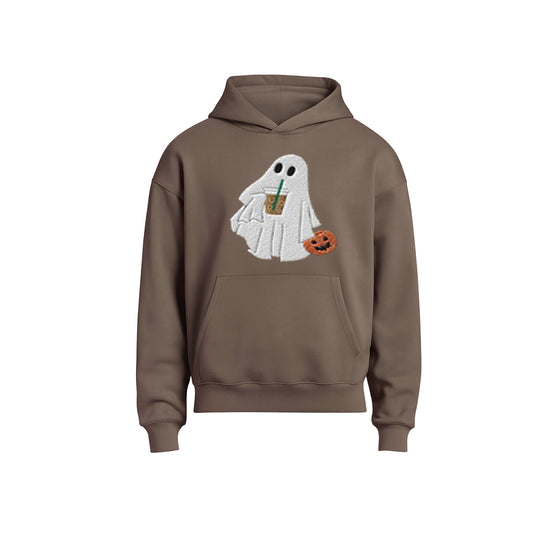 Brown hoodie with a ghost design holding a drink and a pumpkin on a white background