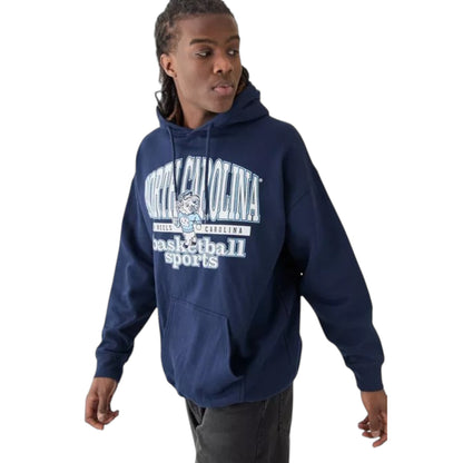 A person wearing a navy oversized North Carolina basketball sports hoodie with a front kangaroo pocket, long sleeves, and a pullover design.