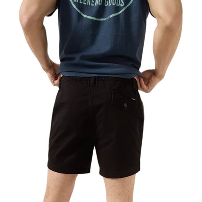 Person wearing a navy tank top and black shorts on a white background