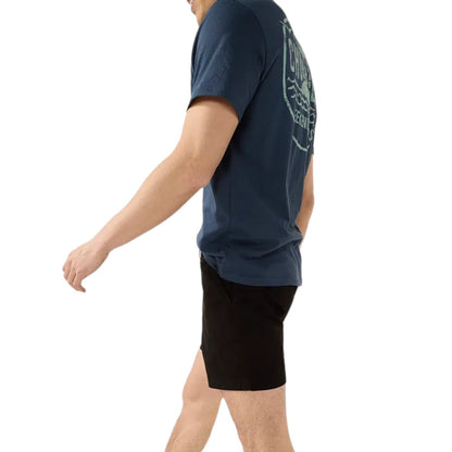 Person wearing a blue t-shirt, black shorts, and white sneakers on a white background
