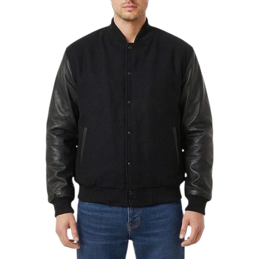 Black varsity jacket with leather sleeves worn by a person on a white background
