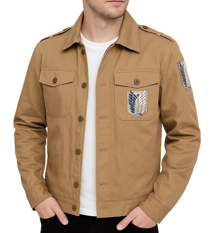 A man wearing a tan military-style field jacket with Attack on Titan insignia patches on the chest and sleeve, layered over a white t-shirt.