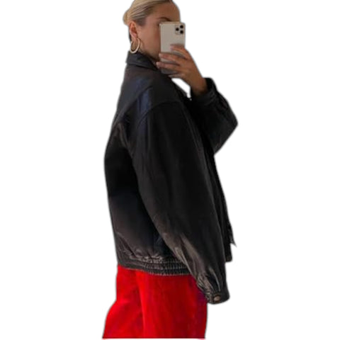 Person wearing a black jacket with red pants on a white background