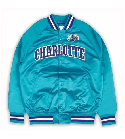 A teal satin varsity jacket with 'CHARLOTTE' arched in purple and white across the chest, featuring a bee mascot patch on the left chest and striped ribbed collar, cuffs, and hem.