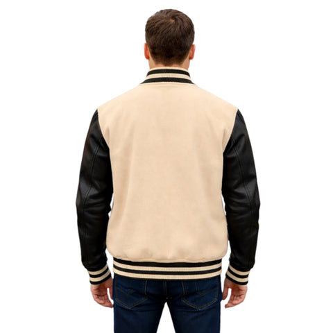 Man wearing a beige varsity jacket with black sleeves on a white background