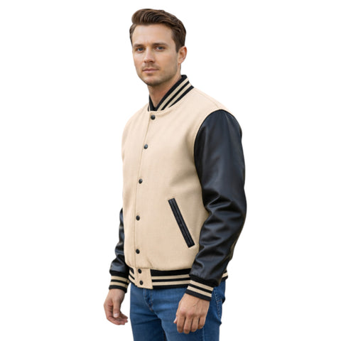 Man wearing a beige and black varsity jacket on a white background