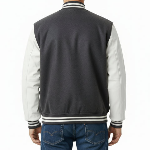 Dark Grey and white varsity jacket with blue jeans on a white background