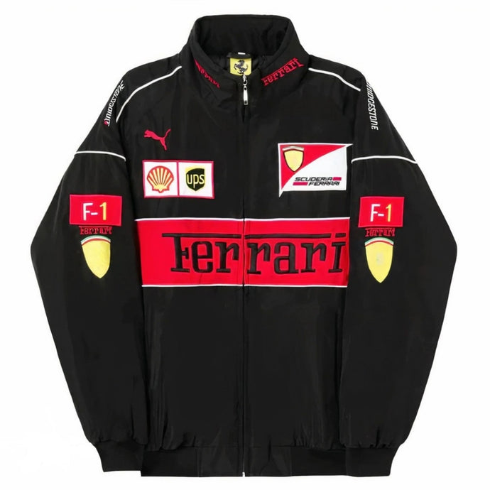 A black Ferrari F-1 racing track jacket with red and white sponsor logos, including Shell, UPS, and Puma, displayed on a solid white background.
