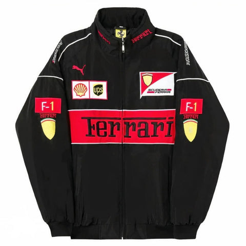 A black Ferrari F-1 racing track jacket with red and white sponsor logos, including Shell, UPS, and Puma, displayed on a solid white background.