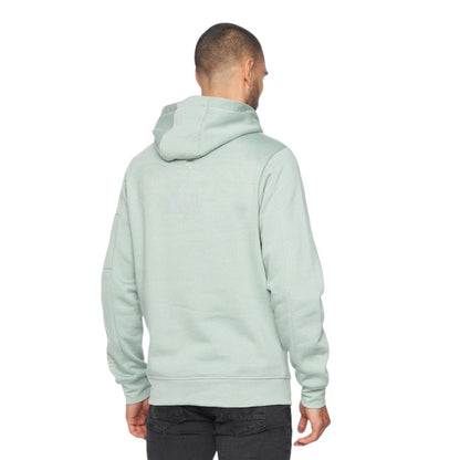 Person wearing a light green hoodie from behind on a white background
