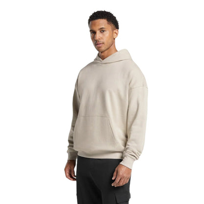 Man wearing a beige hoodie on a white background