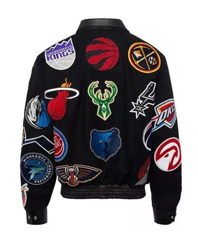 Black bomber jacket featuring multiple embroidered NBA team logos, including the Sacramento Kings, Toronto Raptors, Denver Nuggets, Miami Heat, Milwaukee Bucks, Oklahoma City Thunder, and Atlanta Hawks.