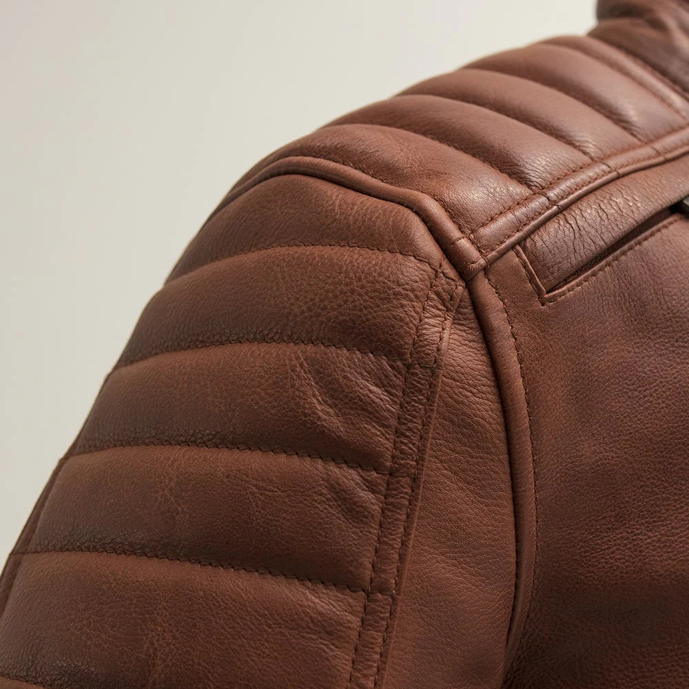 Close-up of a brown leather jacket with quilted pattern