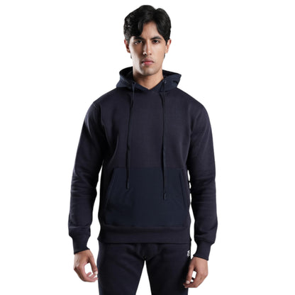 A male model wearing a black thermal track suit top with a hood, featuring a full zip, high collar, ribbed cuffs and hem, side pockets, and an embroidered logo.