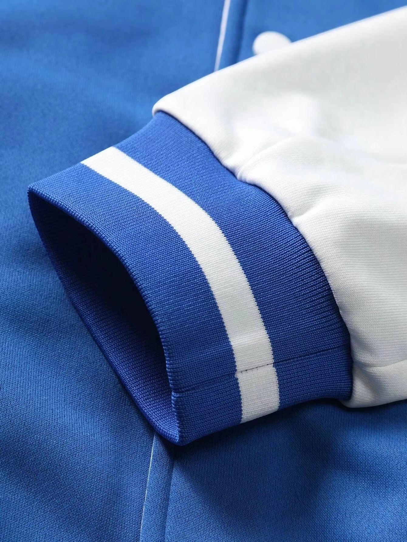 Fit to lead Traders blue and white varsity bomber jacket with ribbed cuffs and collar. Classic letterman streetwear coat.