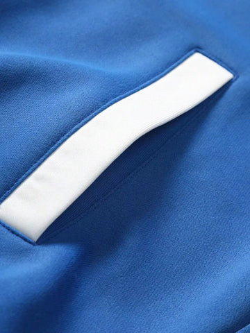 Fit to lead Traders blue and white varsity bomber jacket detail showing pocket with white trim.