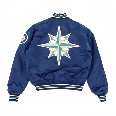 A navy blue satin bomber jacket shown from the back, featuring a large Seattle Mariners baseball-themed compass star logo on the back in teal, white, and red, with striped ribbed collar, cuffs, and hem.