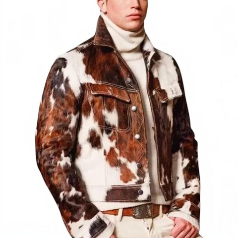 A man wearing a brown and white cow-print jacket over a cream turtleneck sweater, paired with beige pants and a brown belt, against a plain white background.