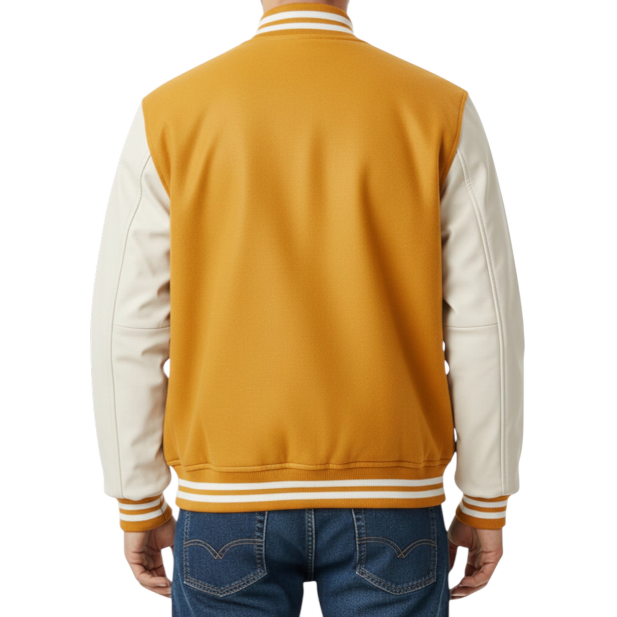 Back view of a person wearing a mustard yellow and white varsity jacket with blue jeans on a white background