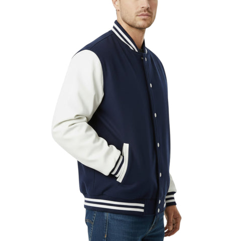 Man wearing a navy and white varsity jacket on a white background