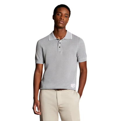 A man wearing a light gray polo shirt with a classic collar and a three-button placket.