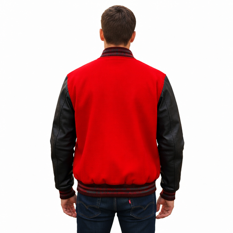 A man viewed from the back wearing a red and black varsity-style jacket with black leather-look sleeves, ribbed knit collar and hem, and dark blue jeans against a plain white background.
