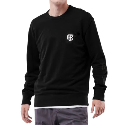 A person wearing a black crew neck sweatshirt with a small logo on the chest.