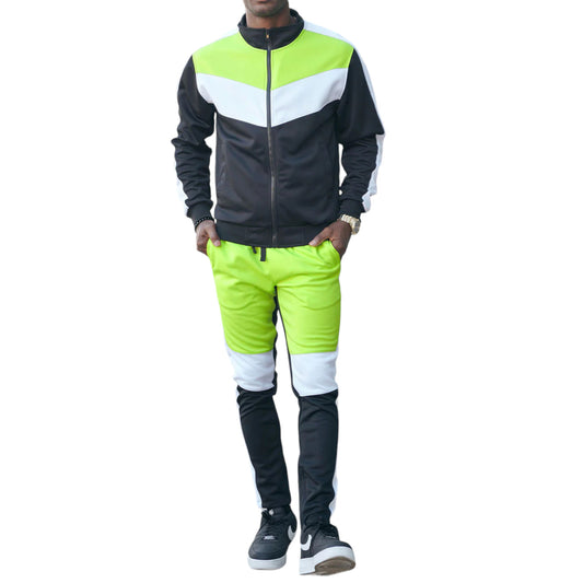 A man wearing a two-tone track suit with a color block design, featuring a full-zip jacket in black and white, and matching joggers in bright green and white.