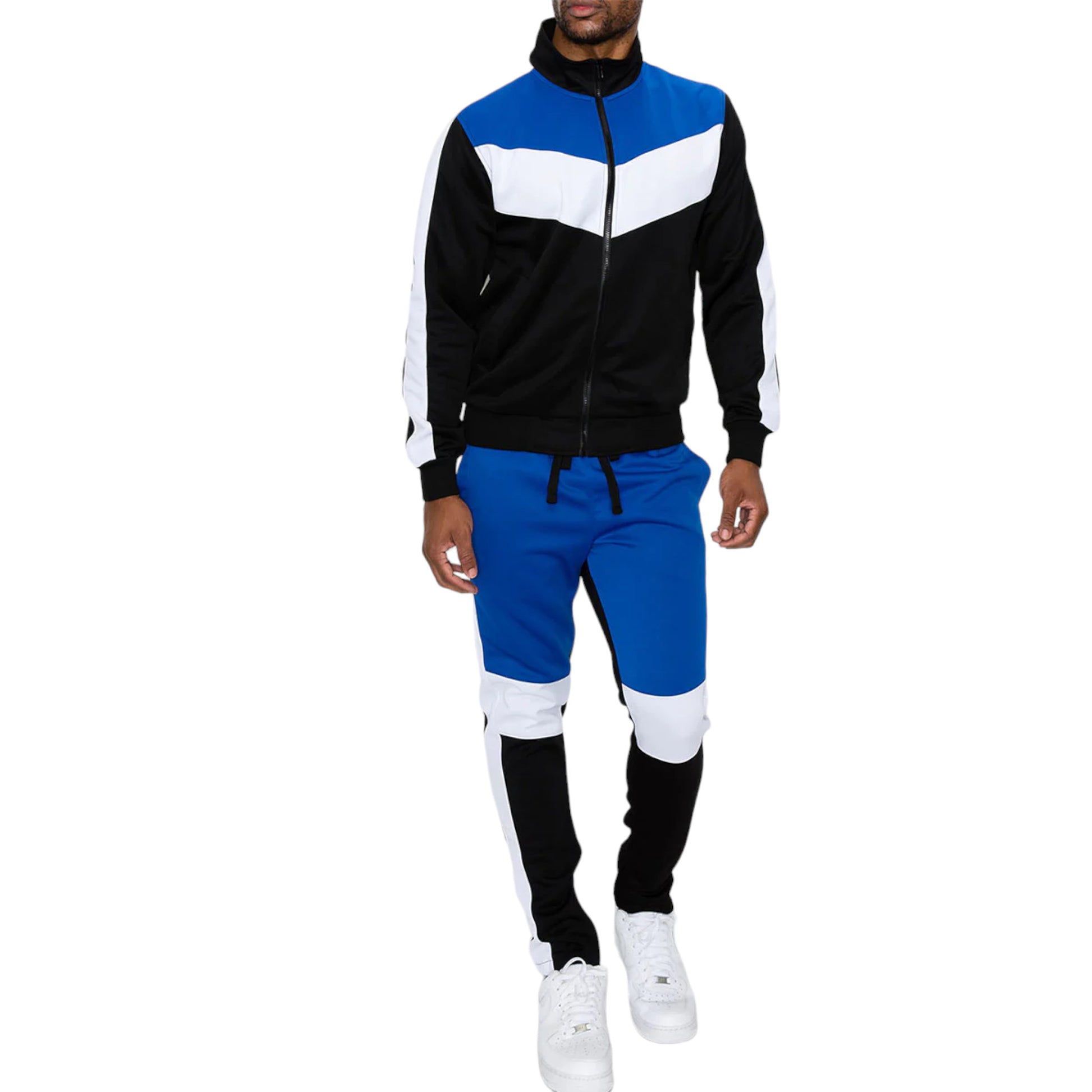 A man wearing a color block track suit with a full zip jacket and matching joggers in blue, black, and white colors.