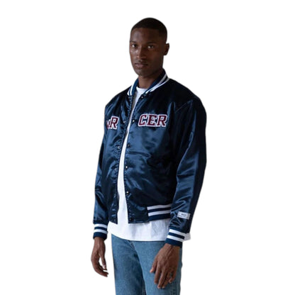 A person wearing a navy varsity jacket with 'MERCER' embroidery on the chest and striped sleeves.