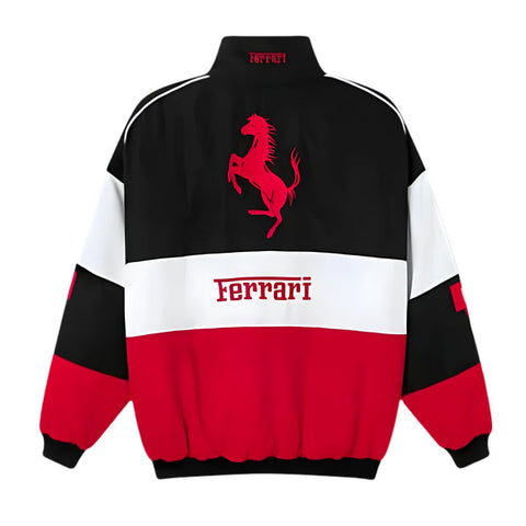 A Ferrari colorblock jacket shown from the back, featuring a black upper section with a red prancing horse logo, a white middle band with 'Ferrari' text, and a red lower section, on a white background.